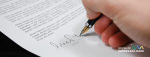 An image of someone signing a document. The image represents the importance of understanding workers' rights to ensure their rights are not violated.